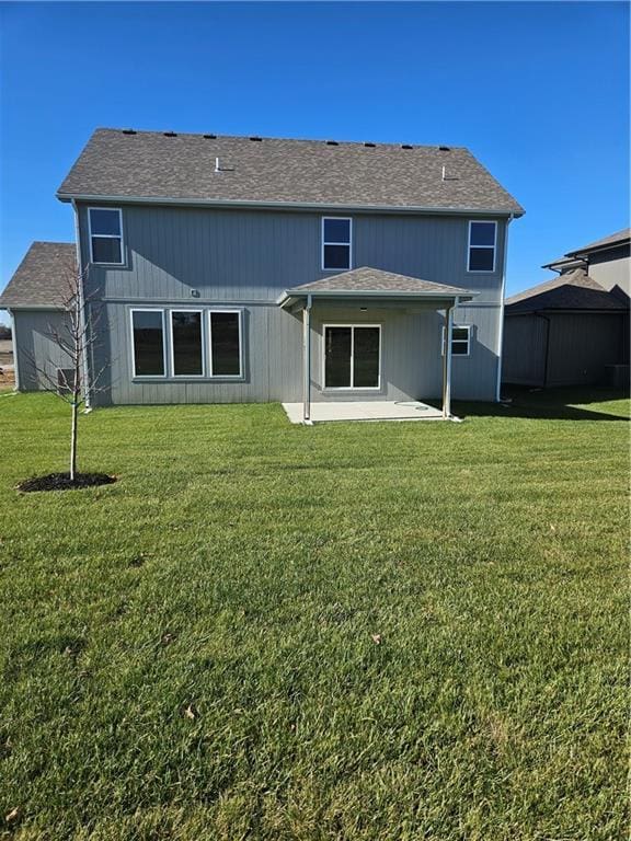 back of property with a patio area and a yard