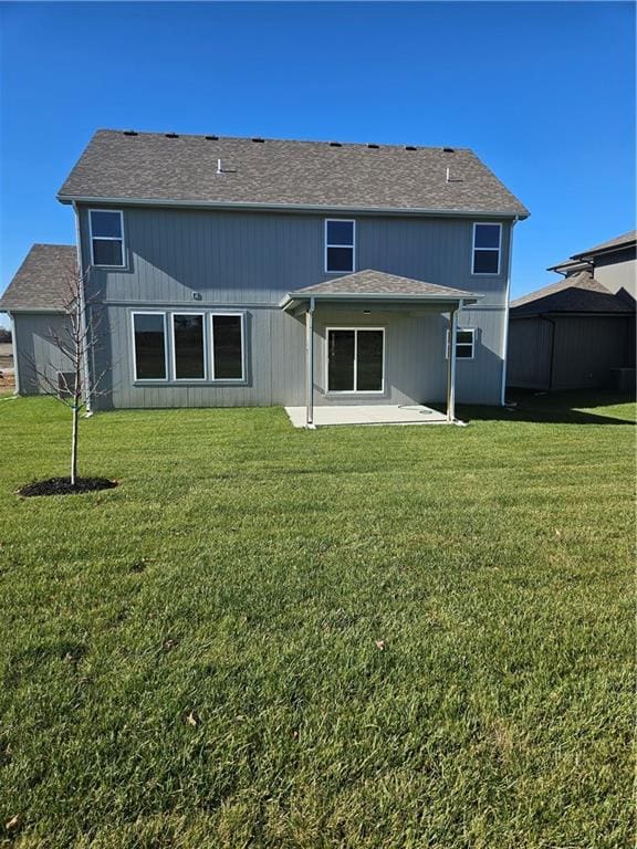 rear view of property with a lawn and a patio area