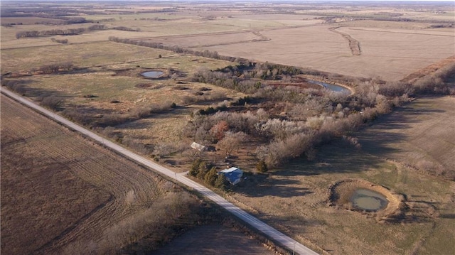 birds eye view of property with a rural view