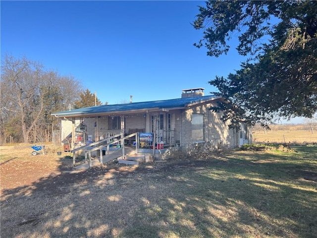 rear view of house with a yard