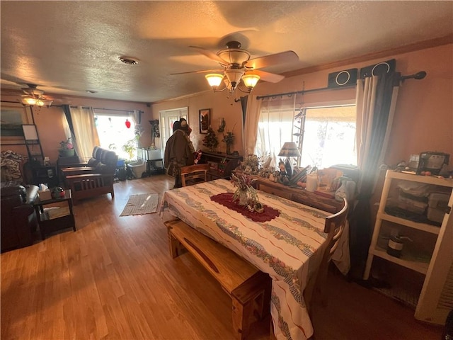 dining room with a healthy amount of sunlight, hardwood / wood-style floors, and ceiling fan