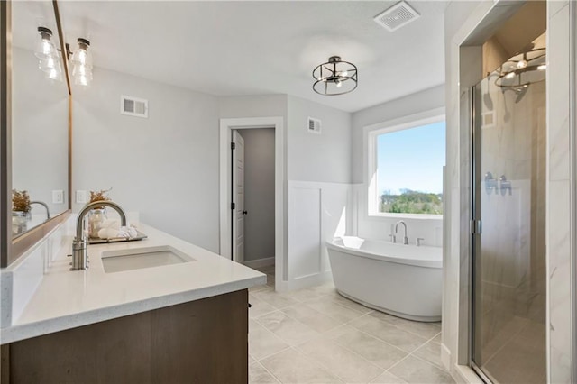 bathroom with vanity, shower with separate bathtub, a chandelier, and tile patterned floors