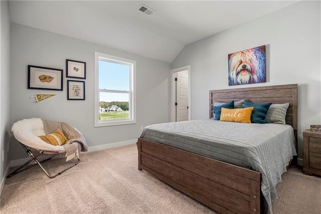 bedroom with light carpet and lofted ceiling