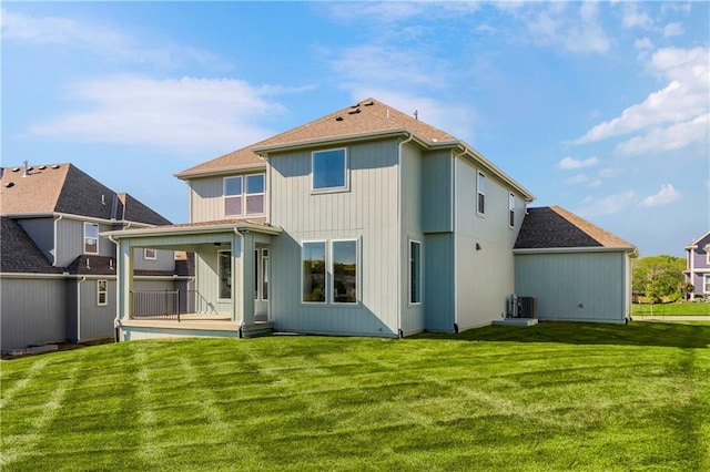 rear view of house featuring a storage shed and a yard