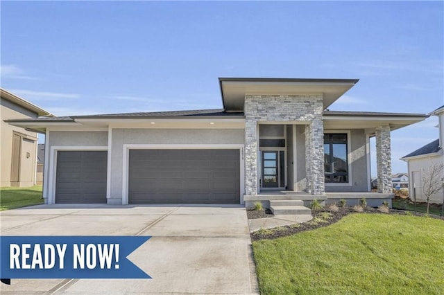 16879 S Cardinal St, Olathe, KS 66062 - view of front facade featuring stone siding, concrete driveway, a garage, a front lawn, and stucco siding