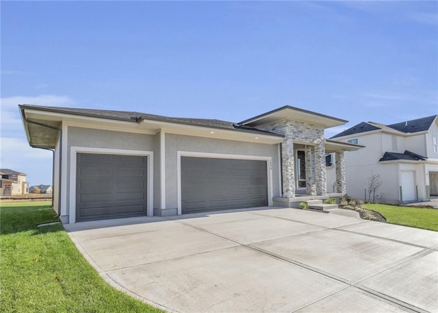 16879 S Cardinal St, Olathe, KS 66062 - prairie-style house featuring an attached garage, concrete driveway, stucco siding, and a front lawn