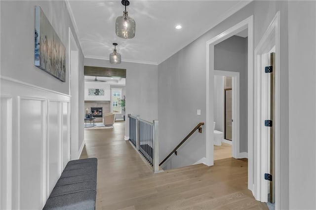 16879 S Cardinal St, Olathe, KS 66062 - hallway with an upstairs landing, ornamental molding, and wood finished floors