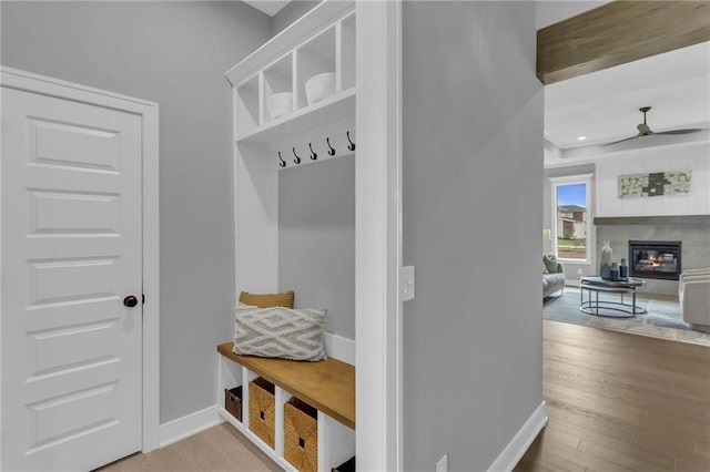 16879 S Cardinal St, Olathe, KS 66062 - mudroom featuring wood finished floors, baseboards, a glass covered fireplace, and recessed lighting