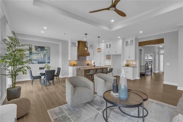16879 S Cardinal St, Olathe, KS 66062 - living room with wood finished floors, recessed lighting, ceiling fan, a raised ceiling, and baseboards