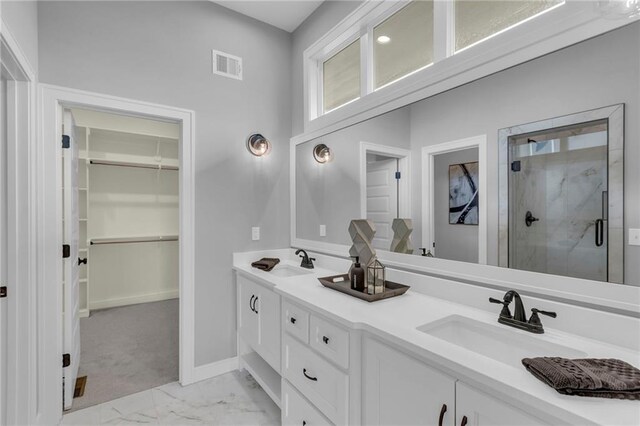 16879 S Cardinal St, Olathe, KS 66062 - bathroom featuring a stall shower, marble look tiles, a walk in closet, double vanity, and baseboards