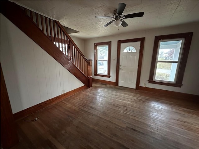 foyer entrance with dark wood-style floors, visible vents, a textured ceiling, baseboards, and stairs