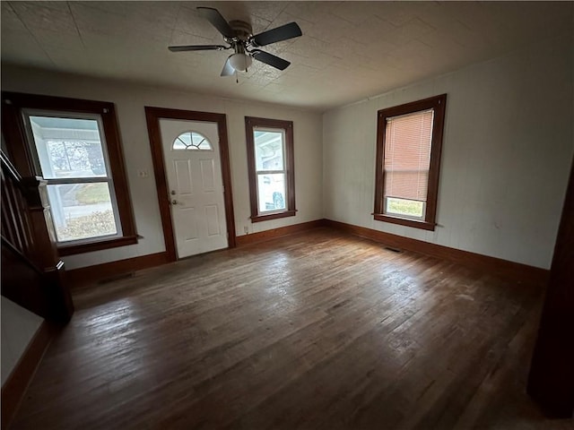 entryway with dark wood-style flooring, visible vents, ceiling fan, and baseboards