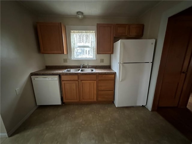 kitchen with white appliances, baseboards, brown cabinetry, and a sink