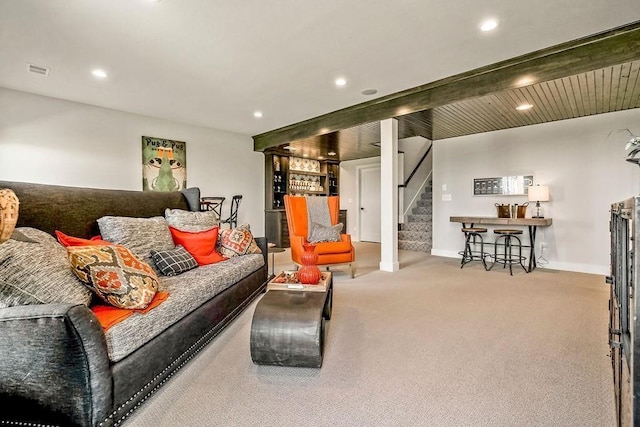 carpeted living room featuring beamed ceiling