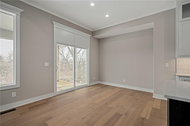 interior space with light hardwood / wood-style floors and crown molding