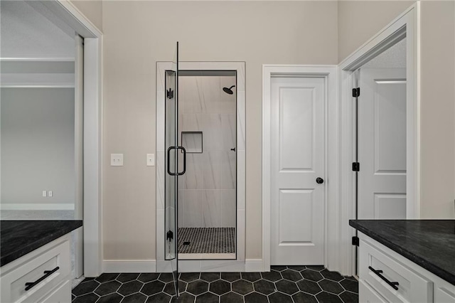 bathroom with vanity and a shower with door