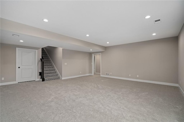 basement featuring light carpet