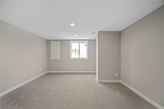 spare room featuring light colored carpet