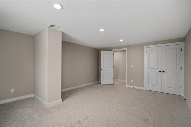 interior space with light carpet and a closet