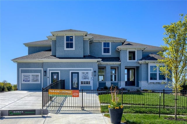 view of front of property with a front lawn and a garage