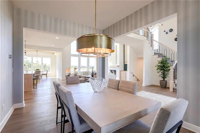 dining space featuring light hardwood / wood-style flooring and a chandelier