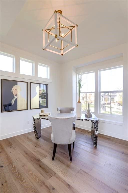 office with hardwood / wood-style flooring and a chandelier