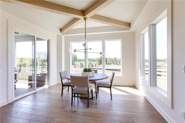 dining room with wood-type flooring, beamed ceiling, and a chandelier