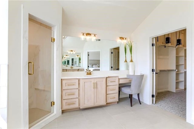 bathroom with walk in shower, tile patterned floors, vanity, and lofted ceiling