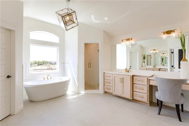 bathroom with tile patterned floors, vaulted ceiling, vanity, and separate shower and tub