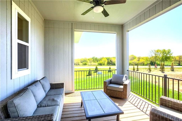 deck featuring ceiling fan and a yard