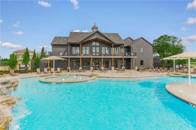 view of swimming pool with a patio and pool water feature