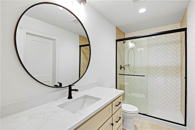 bathroom with vanity, toilet, and an enclosed shower