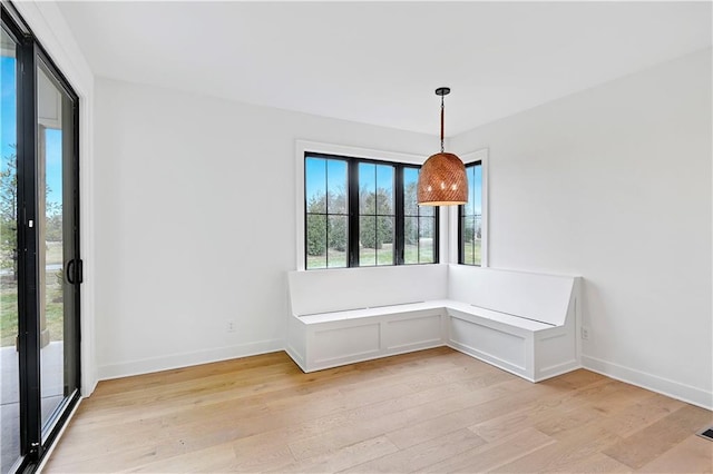 unfurnished dining area featuring a healthy amount of sunlight and light wood-type flooring