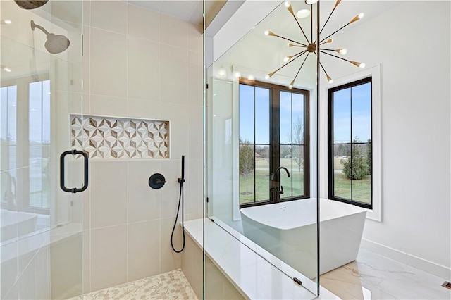 bathroom with plus walk in shower and an inviting chandelier