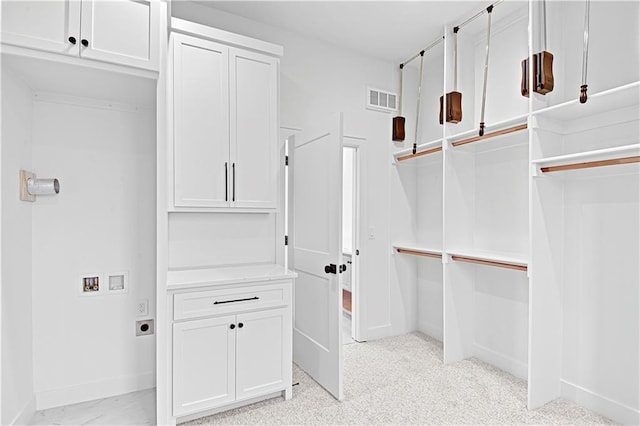 spacious closet with light carpet