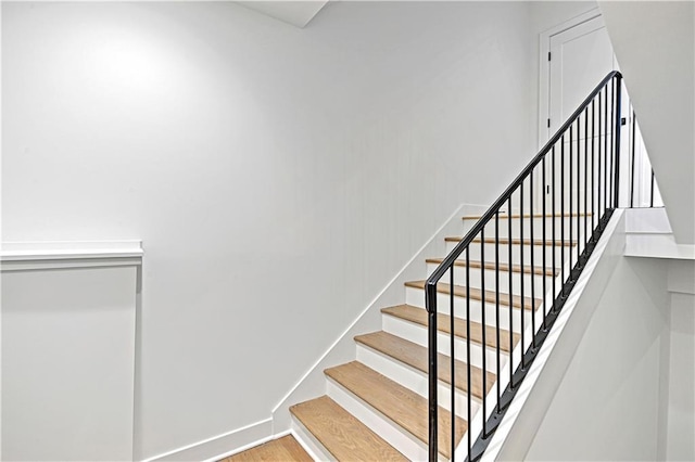 stairs with hardwood / wood-style flooring