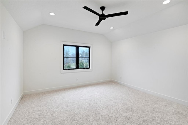 spare room featuring lofted ceiling, ceiling fan, and carpet