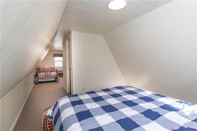 carpeted bedroom with lofted ceiling