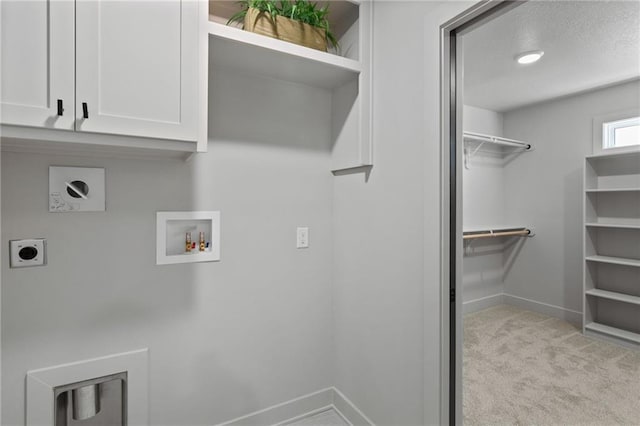 washroom featuring cabinets, a textured ceiling, light carpet, washer hookup, and hookup for an electric dryer