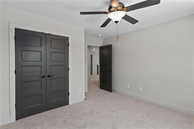 unfurnished bedroom featuring a closet, light carpet, and ceiling fan