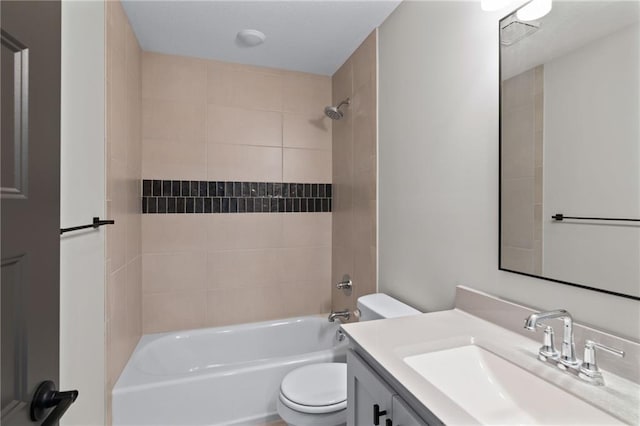 full bathroom with vanity, toilet, and tiled shower / bath