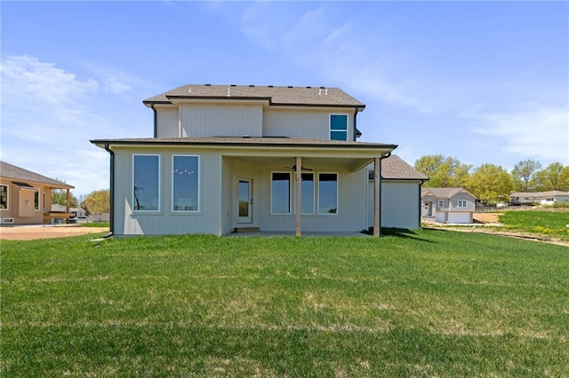 rear view of house with a lawn