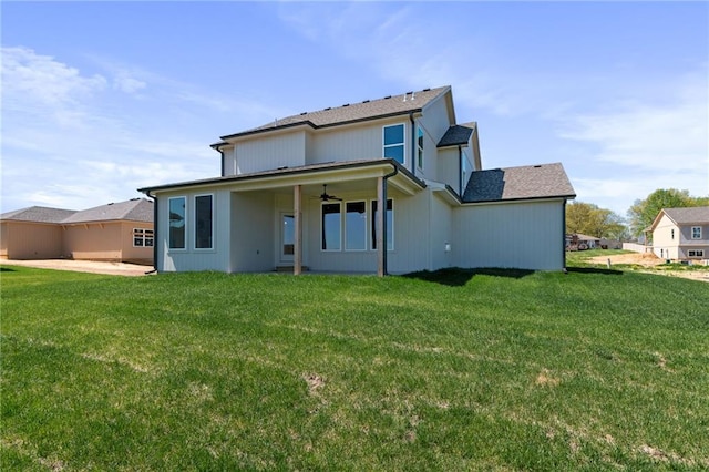 back of house featuring ceiling fan and a yard