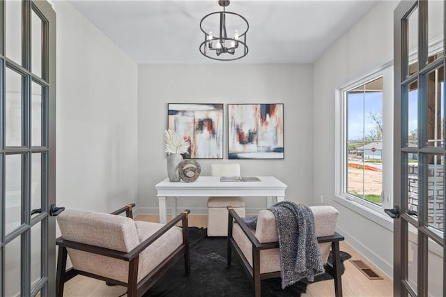 office with a notable chandelier and hardwood / wood-style flooring