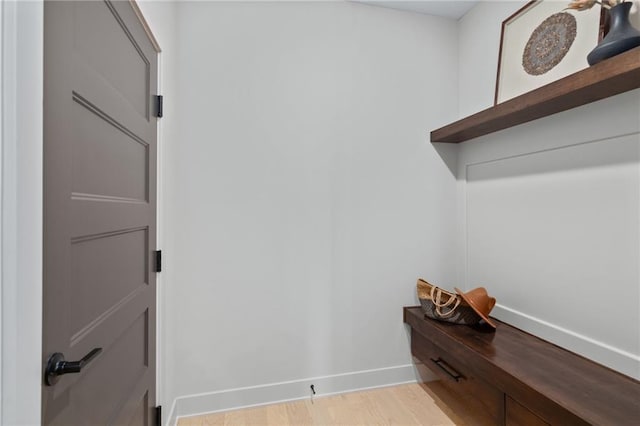 walk in closet with light hardwood / wood-style flooring