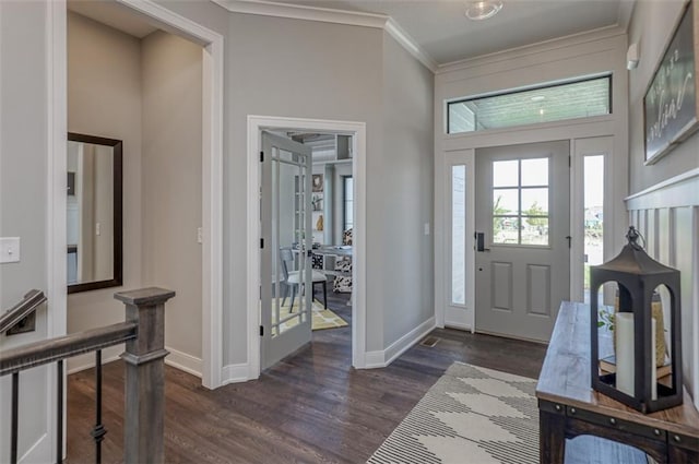 foyer featuring dark wood-type flooring and crown molding