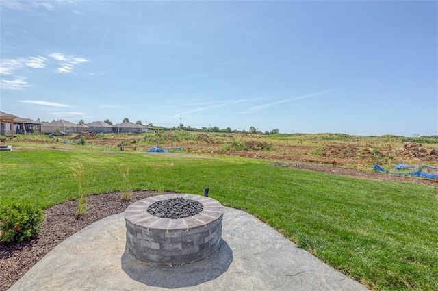 view of yard with a patio and an outdoor fire pit