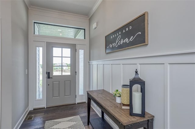 entrance foyer with crown molding and dark hardwood / wood-style floors