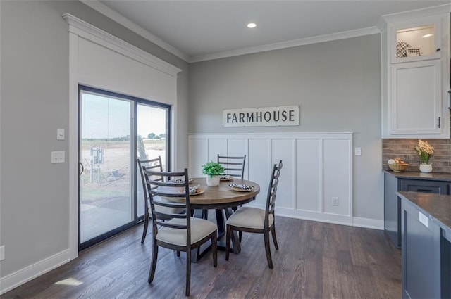 dining space featuring crown molding and dark hardwood / wood-style floors