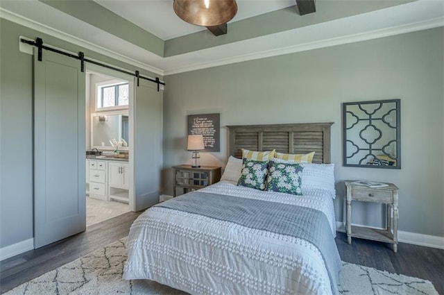 bedroom featuring ensuite bathroom, ceiling fan, crown molding, a barn door, and dark hardwood / wood-style floors